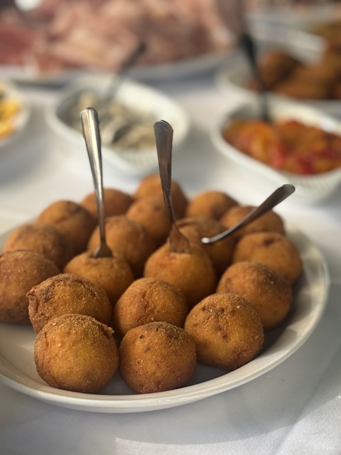 Golden arancini presented on a platter at a catered gathering