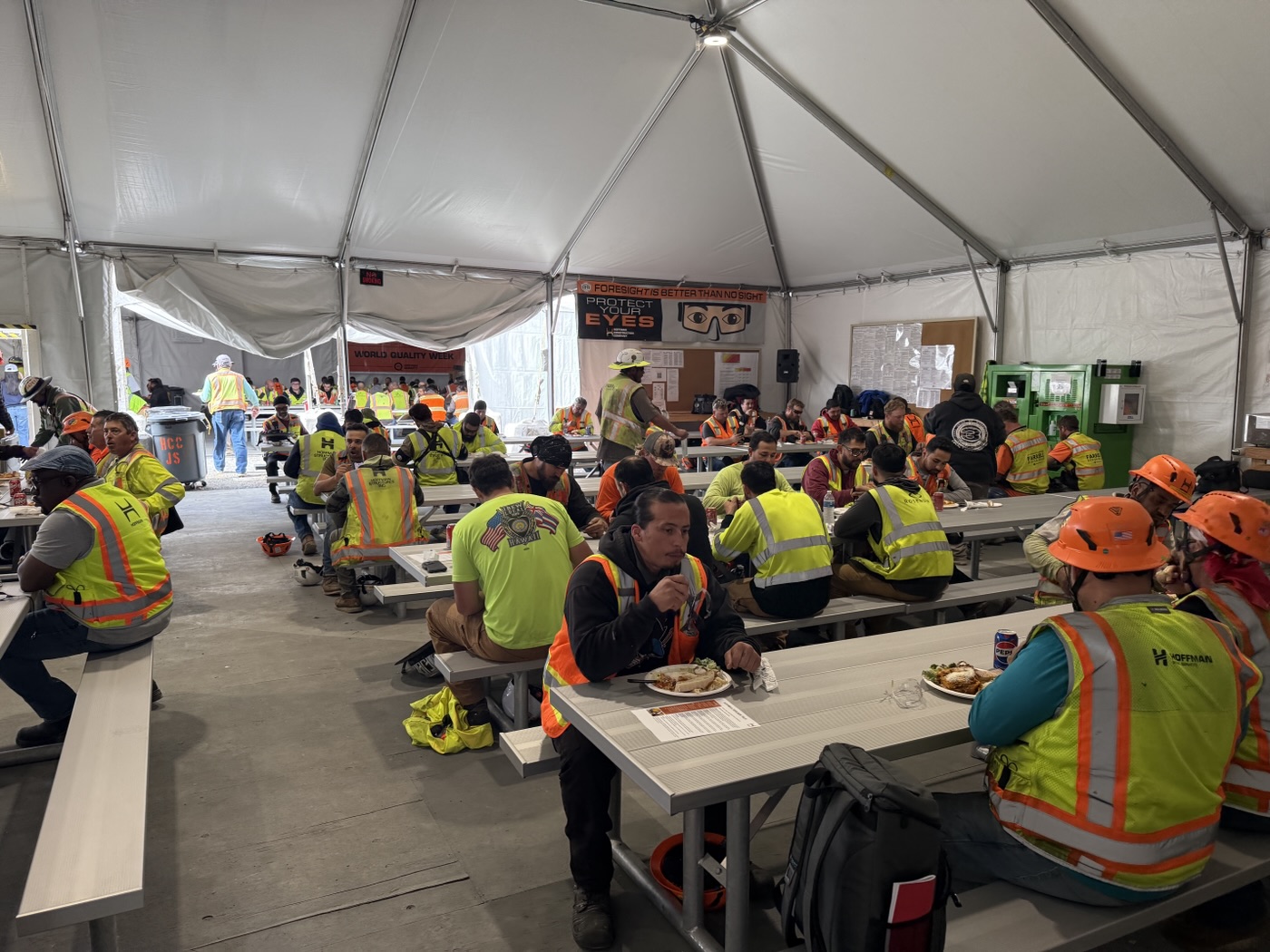 Guests sharing an Italian Brothers catered meal at a workplace event