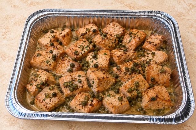 Salmon Piccata served in a party tray